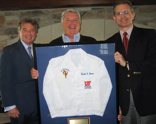Dr.’s Mark Gold and Bruce Kone present White Coat to Don Dizney